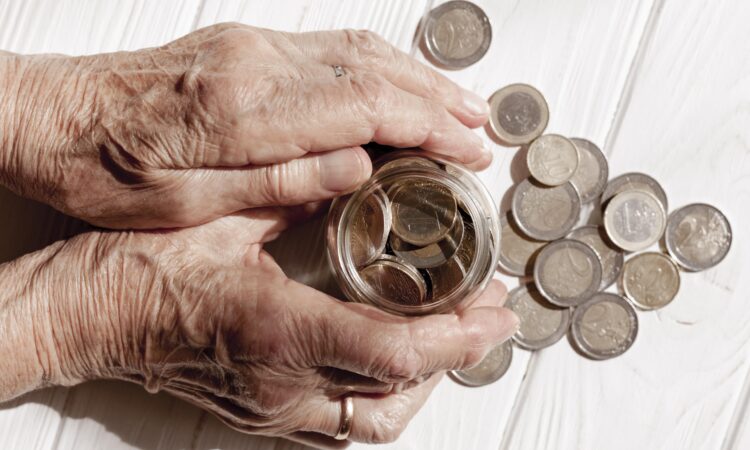 hands-holding-jar-filled-with-coins